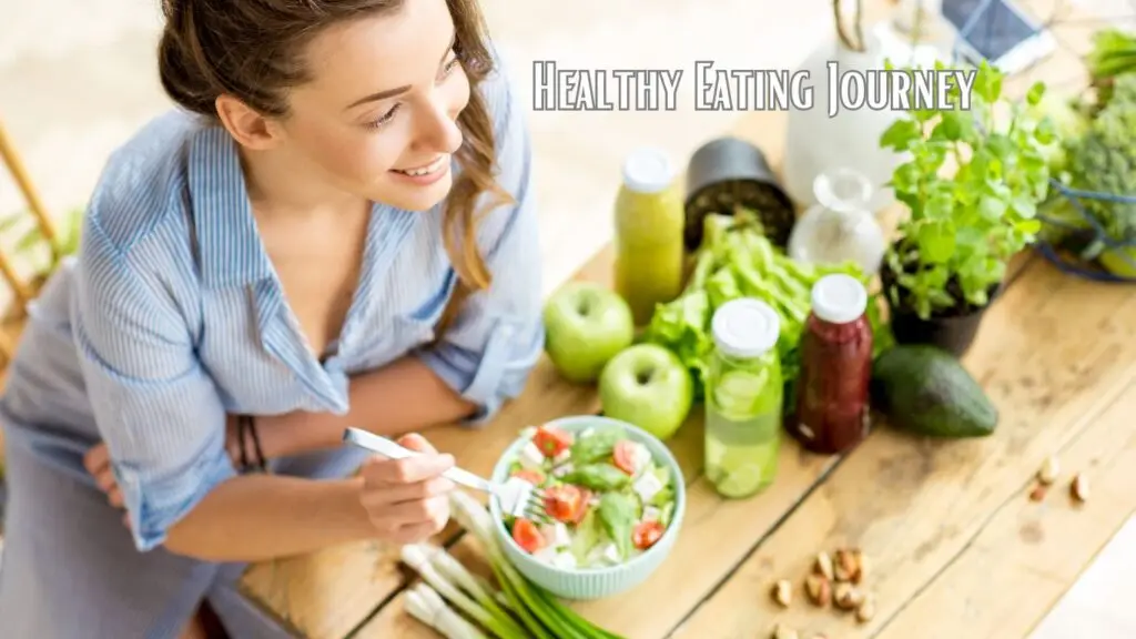 A person enjoying a healthy meal at a wooden table with salad, green apples, and fresh vegetables.