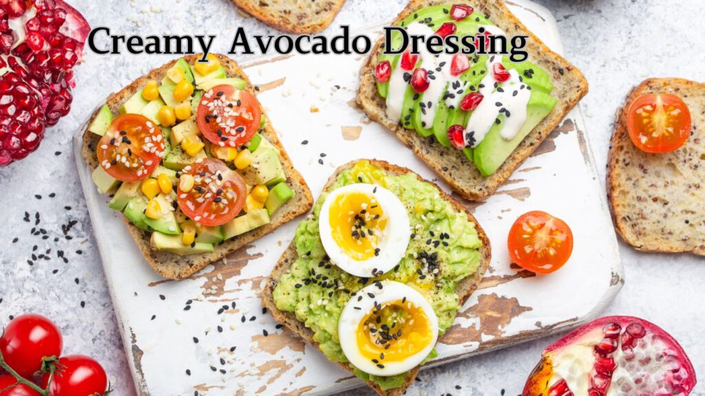 A plate with avocado toast topped with various ingredients such as tomatoes, corn, seeds, and a drizzle of creamy avocado dressing.