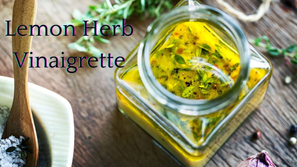 A glass jar filled with lemon herb vinaigrette placed on a wooden surface, surrounded by herbs and spices.