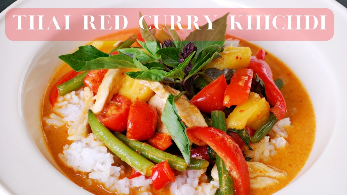 A colorful dish labeled ‘Thai Red Curry Khichdi’ with white rice and various vegetables in a red curry sauce, garnished with green and purple leaves.