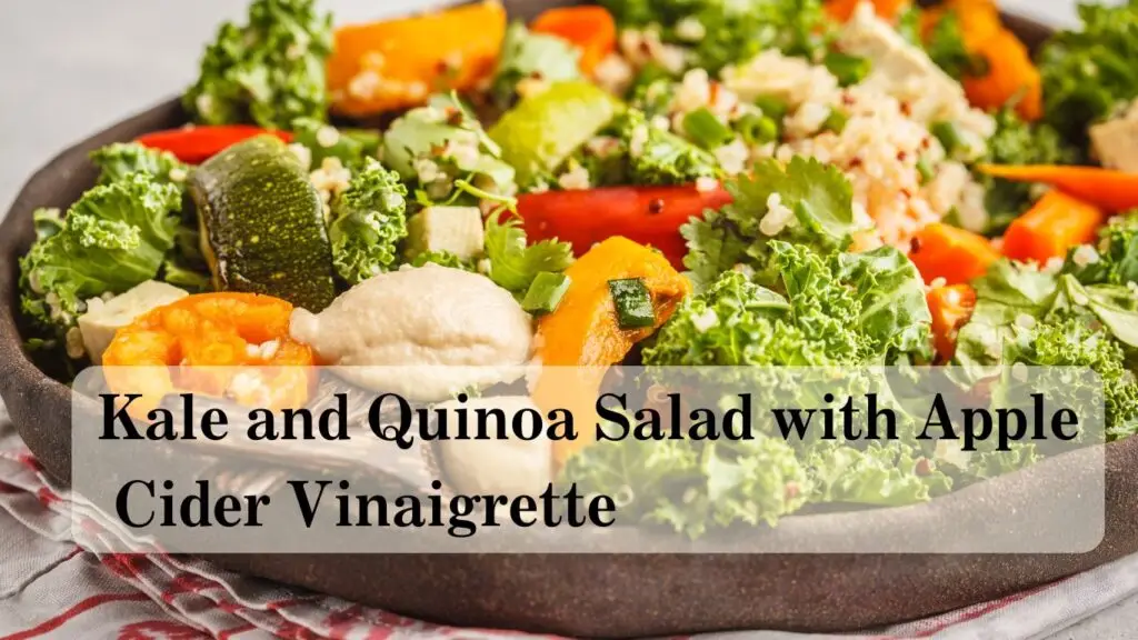 A colorful kale and quinoa salad with apple cider vinaigrette served on a plate.