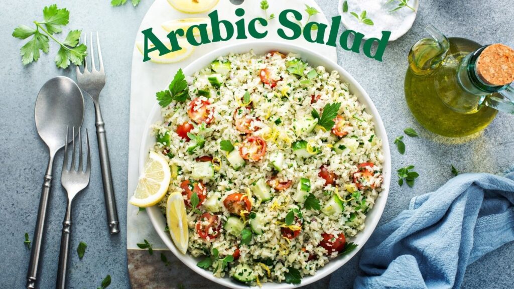 A vibrant bowl of Arabic salad with couscous, herbs, and vegetables on a textured blue surface.