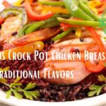 A colorful dish of crock pot chicken breast with traditional flavors, served on a bed of black rice and garnished with sliced bell peppers.