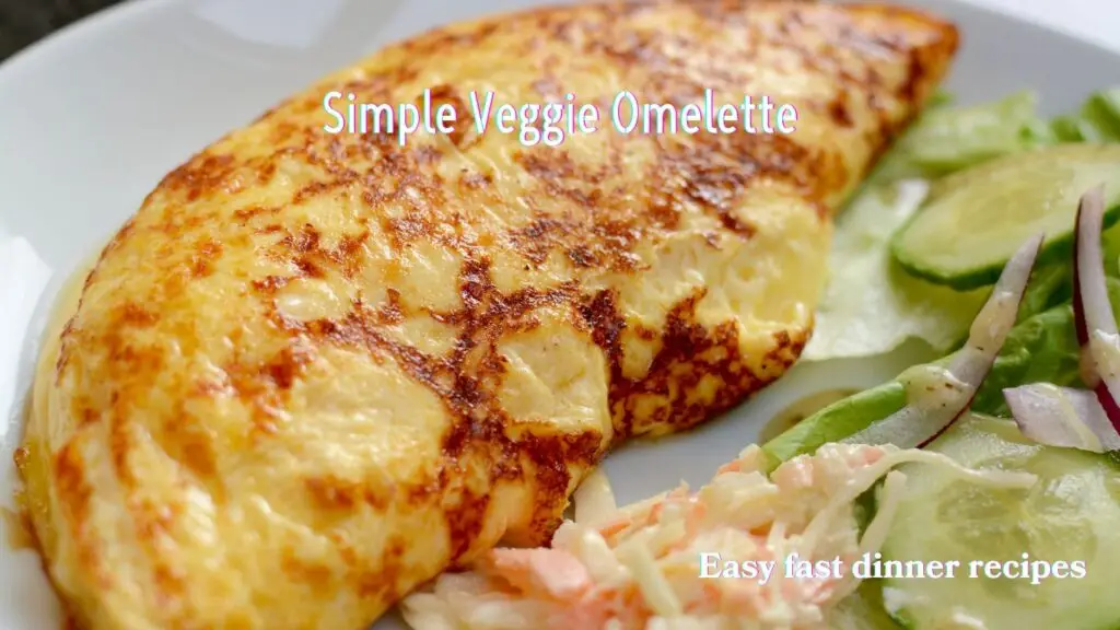 A photo of a golden-brown veggie omelette on a white plate, accompanied by a side salad.