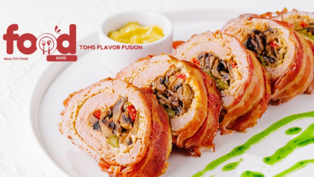 Sliced bacon-wrapped meatloaf stuffed with mushrooms and vegetables on a white plate with mustard sauce and green sauce garnish.