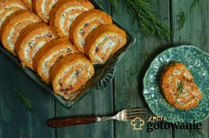 A savory carrot roulade sliced and served on a white plate, garnished with dried tomatoes and fresh herbs. The vibrant orange carrot roulade contrasts beautifully with the red tomatoes and green herbs.