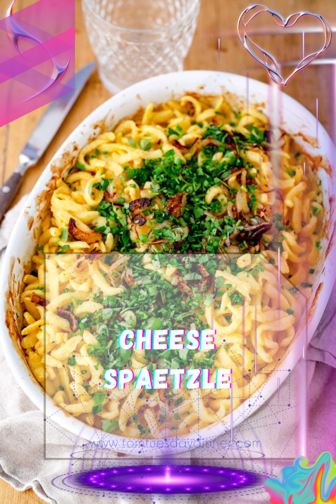 A dish of cheese spaetzle garnished with fresh herbs, placed on a wooden table with a glass of water and a knife beside it.