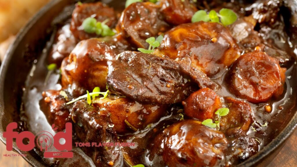 Close-up of a rich and hearty beef stew with tender beef chunks, carrots, and a glossy, savory broth garnished with fresh herbs.