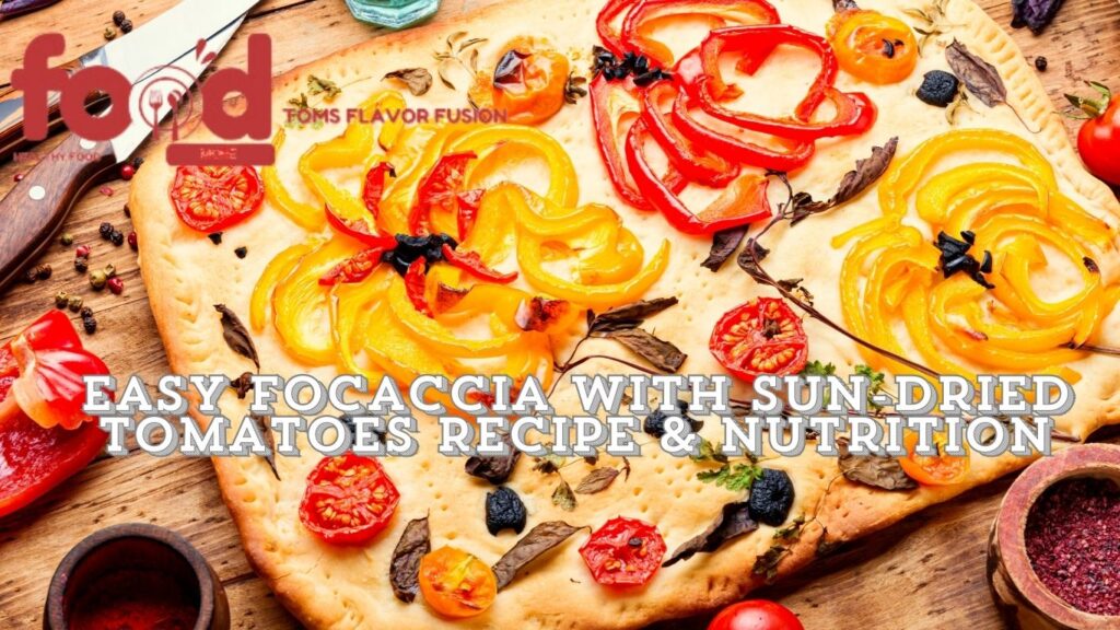 A colorful focaccia bread topped with sun-dried tomatoes, yellow and red bell peppers, and various herbs, displayed on a wooden surface with a knife and scattered peppercorns. The text "Easy Focaccia with Sun-Dried Tomatoes Recipe & Nutrition" is prominently displayed.