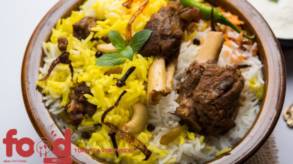 A bowl of biryani with pieces of meat, garnished with mint leaves, cashews, and spices.