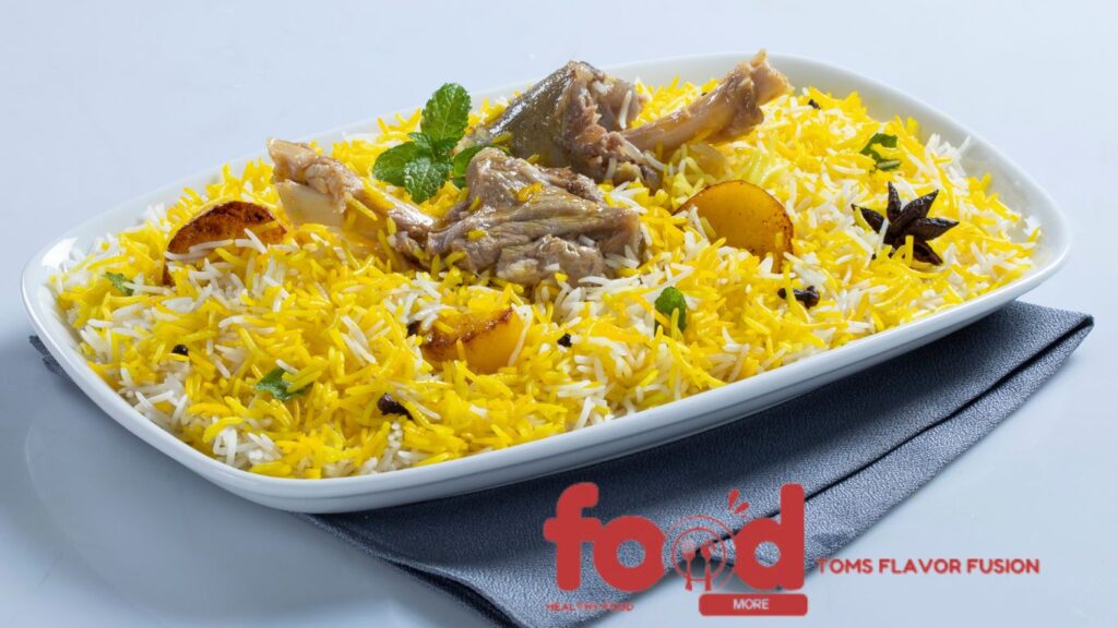 A rectangular white dish filled with yellow and white rice, garnished with pieces of meat, star anise, and mint leaves, placed on a gray napkin. This visual delights as it represents The Legendary Hyderabadi Mutton Biryani: A Culinary Treasure.