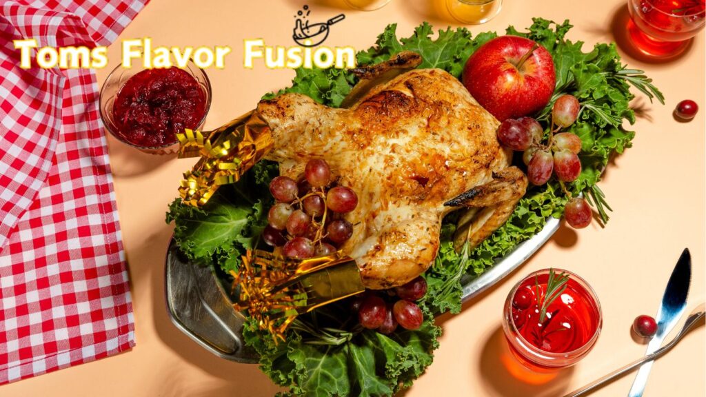 A roasted chicken garnished with grapes and leafy greens, with the text "Toms Flavor Fusion" in yellow at the top.