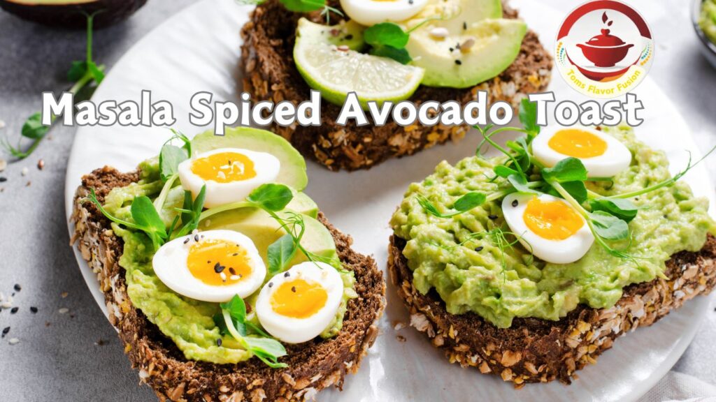 A plate of Masala Spiced Avocado Toast topped with sliced boiled eggs, avocado slices, and microgreens.