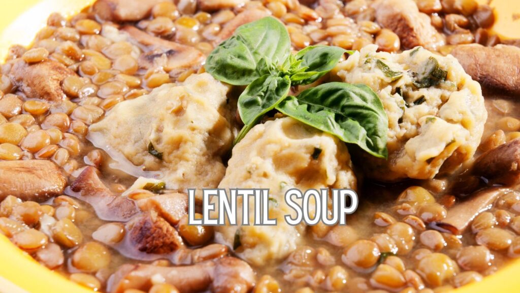 A close-up of a bowl of lentil soup with dumplings and fresh basil leaves on top. The text "LENTIL SOUP" is overlaid on the image.