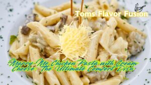 A plate of Marry Me Chicken Pasta with creamy sauce, penne pasta, and a topping of shredded cheese, garnished with fresh herbs.