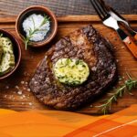 Juicy grilled ribeye steak with herb butter, fresh herbs, and grill marks | Ultimate steak grilling guide