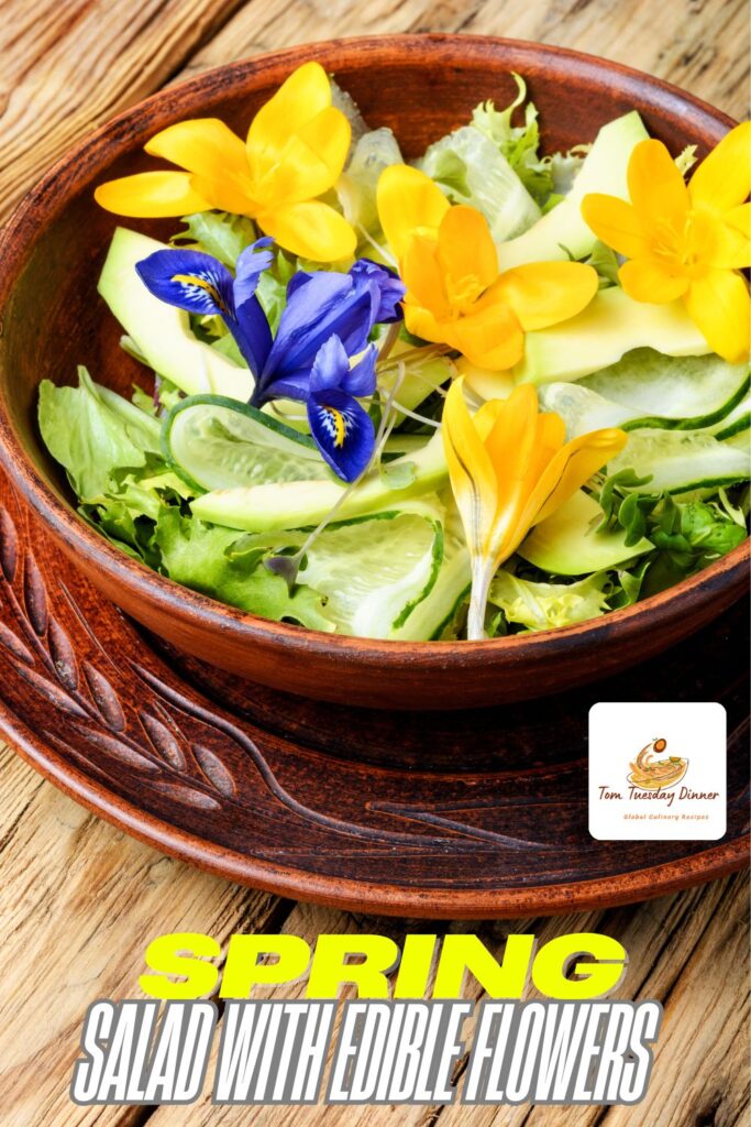 A wooden bowl filled with a fresh salad, garnished with yellow and blue edible flowers, placed on a wooden table. The text "SPRING SALAD WITH EDIBLE FLOWERS" is written at the bottom of the image.